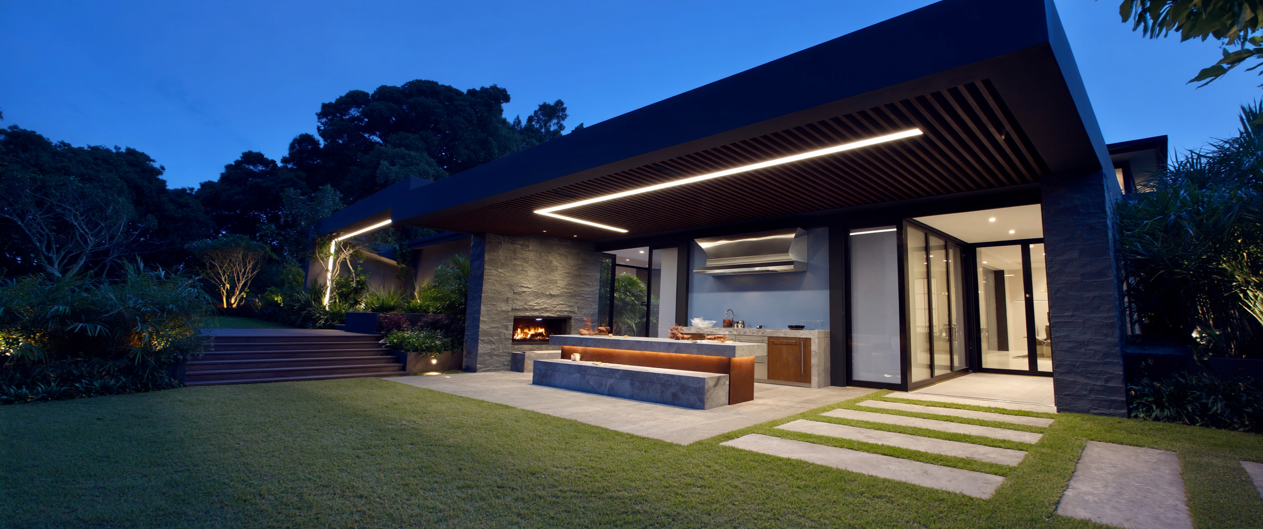 Architectural concept of an illuminated louvred outdoor room at dusk